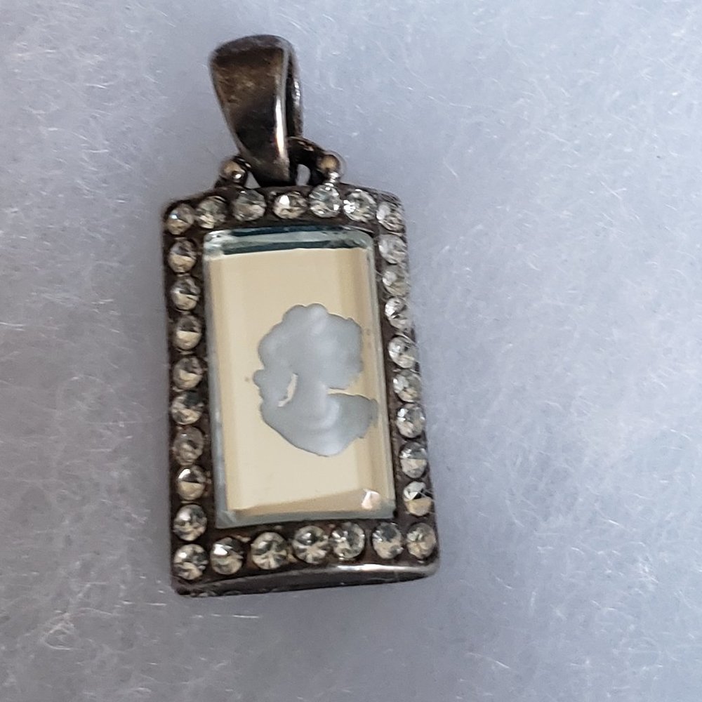 2/10$ Woman profile in a mirror with rhinestones pendant
